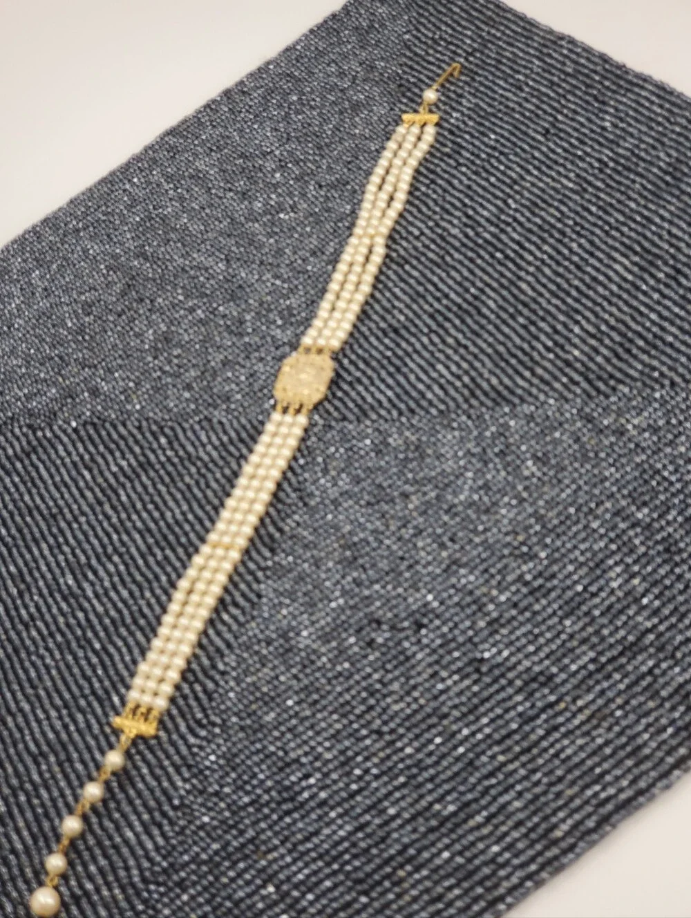 Vintage-style 3-strand pearl choker necklace with a prominent cameo centerpiece